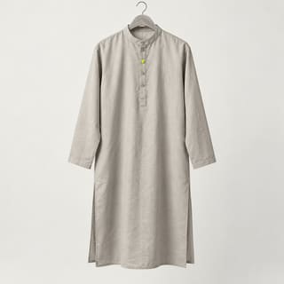 A beige cotton kurta on a hanger with a lime button